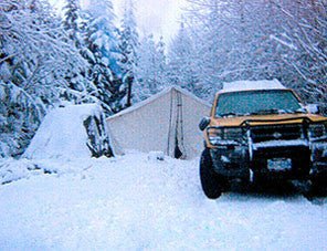 Wall Tent Shop Outfitter Tent in deep snow during camping trip.