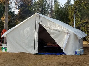 Canvas Hot Tent with open door in a forest setting