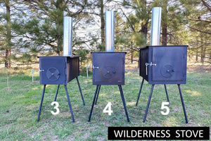 Three wilderness stoves with numbers and a brand name on a grassy area with trees in the background.
