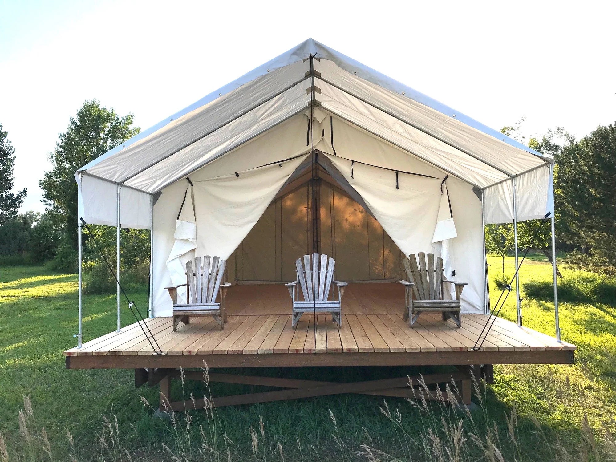 canvas glamping tent on a wooden platform