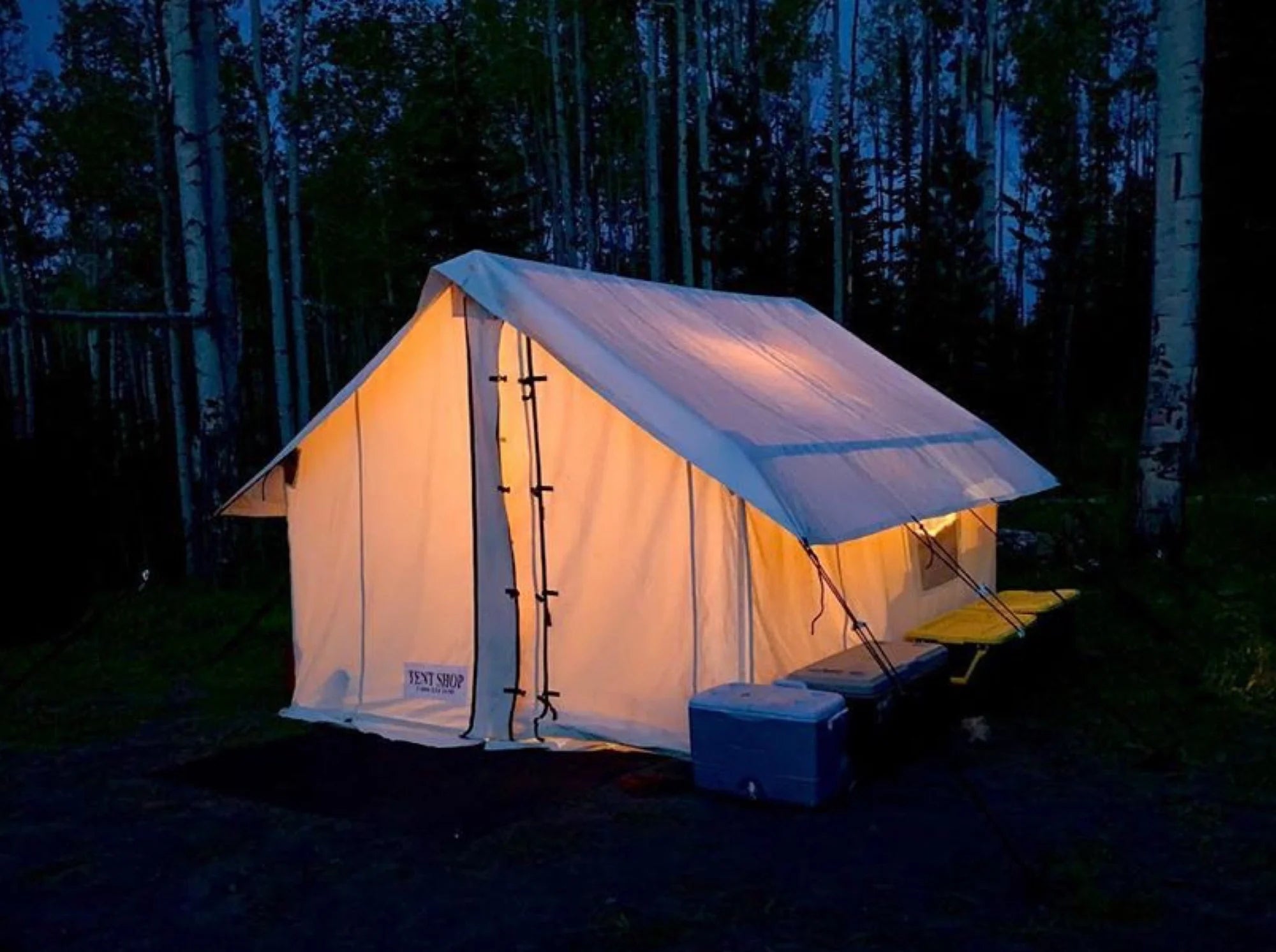 illuminated canvas tent with wood stove