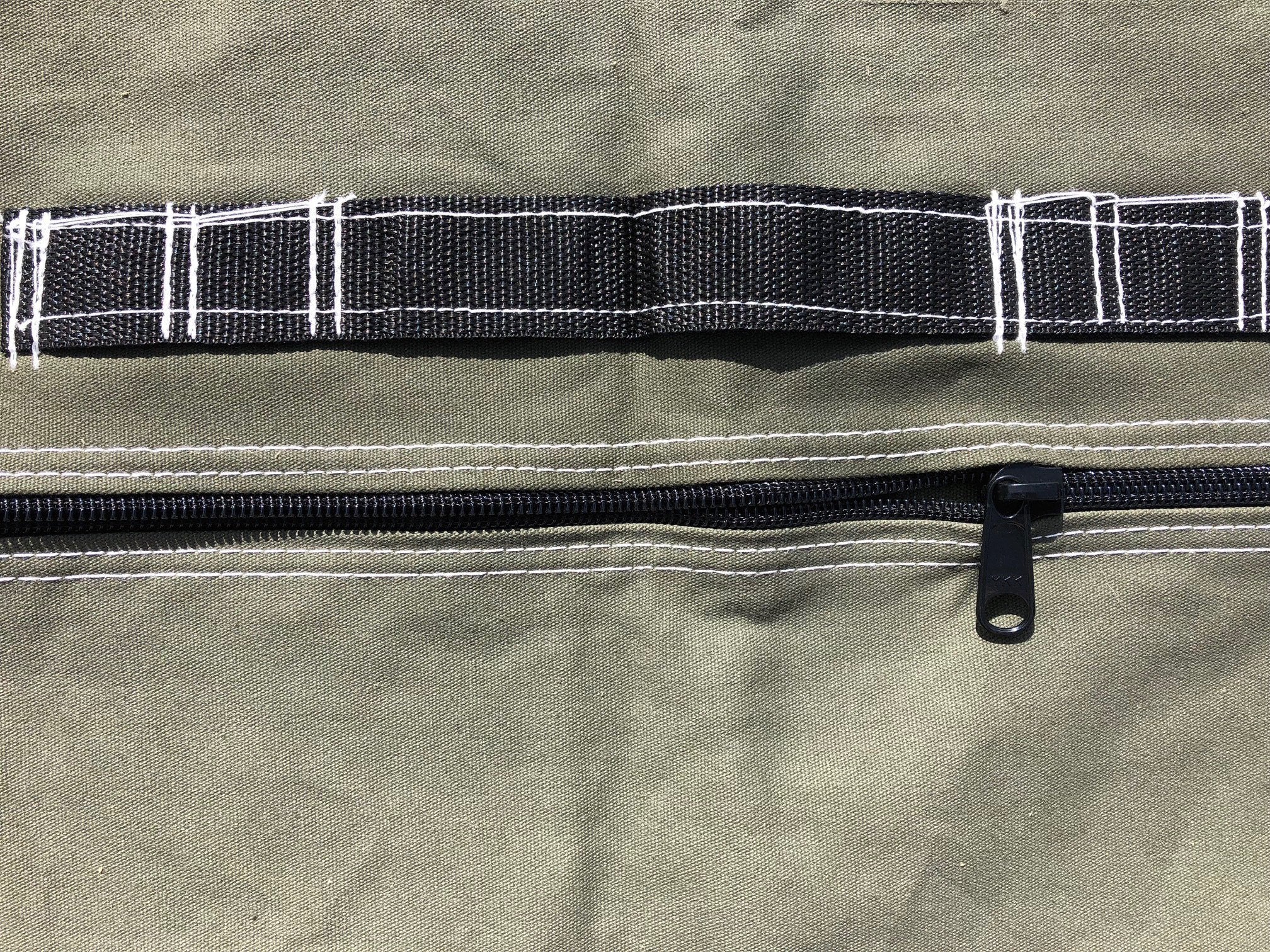 Frame bag showing one handle and zipper.